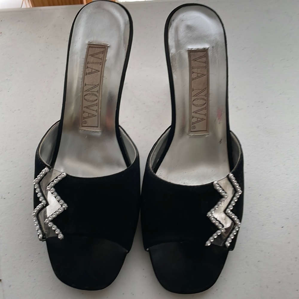 Black suede slip ons with rhinestone detail and acrylic heel